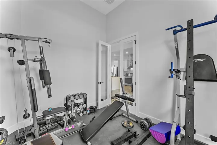 Workout area with a towering ceiling