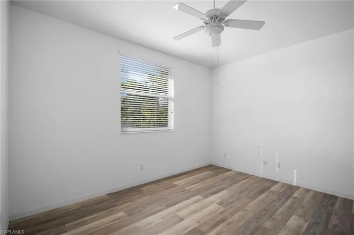 Spare room featuring a ceiling fan and light wood-style floors