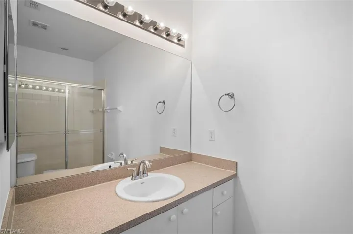 Bathroom featuring vanity and a stall shower