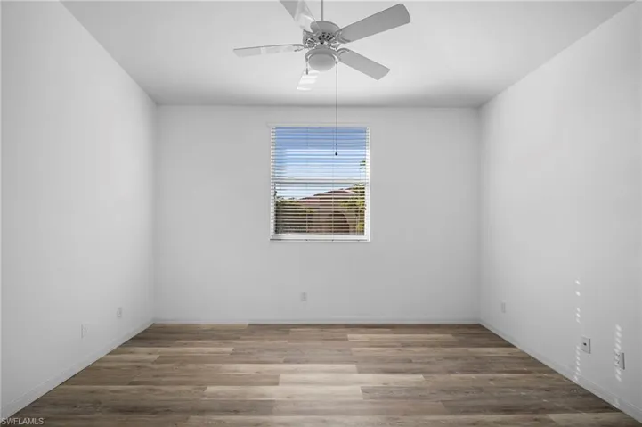 Empty room featuring light wood-style flooring and ceiling fan
