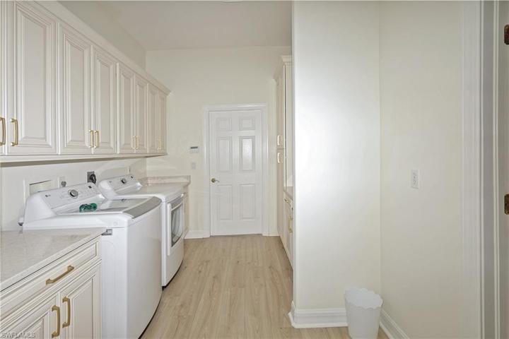 Oversized laundry with TONS of pull out storage and cabinets
