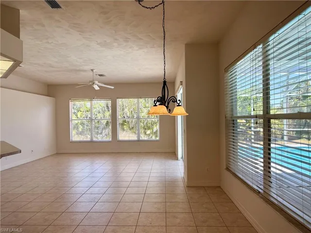 ceiling fan with chandelier, and light tile patterned flooring.