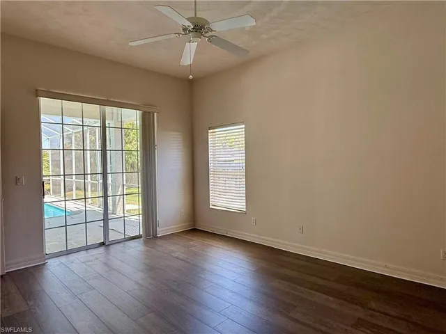 Master bedroom with dark wood finished floors, and ceiling fan