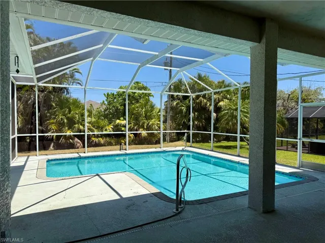 Outdoor pool featuring a lanai and a patio.