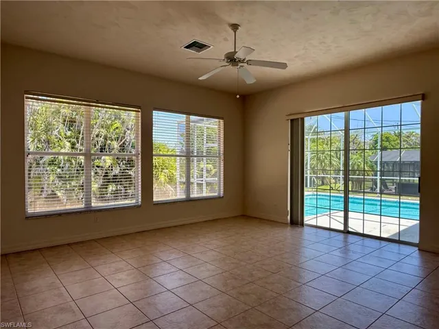 Tiled living room featuring plenty of natural light