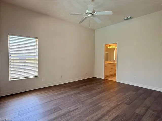 Master bedroom featuring a ceiling fan, and dark wood-type flooring.