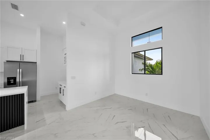 Unfurnished living room featuring light tile floors