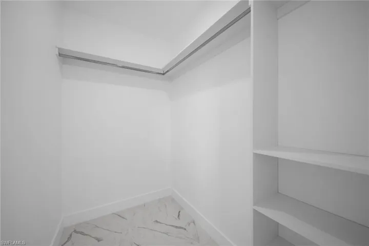 Spacious closet featuring tile floors