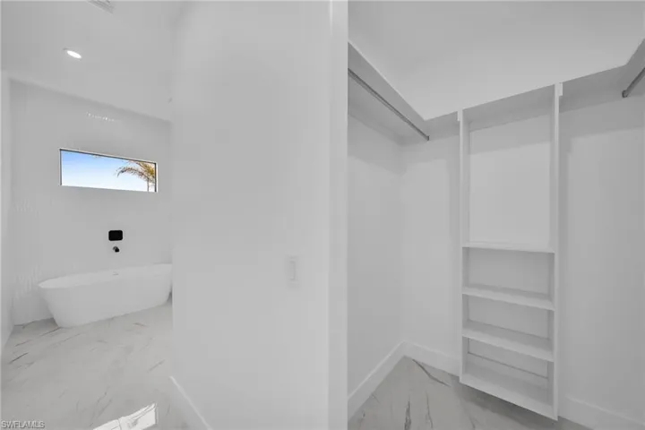 Walk in closet featuring tile floors