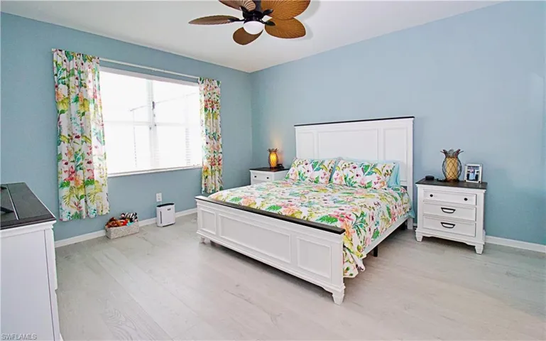 Bedroom with ceiling fan and light hardwood / wood-style flooring