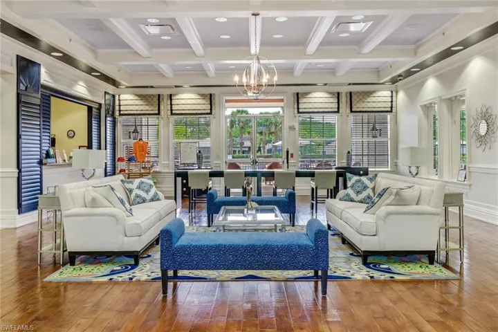 Sunroom featuring an inviting chandelier, beamed ceiling, and coffered ceiling