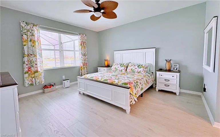Bedroom with ceiling fan and light hardwood / wood-style floors