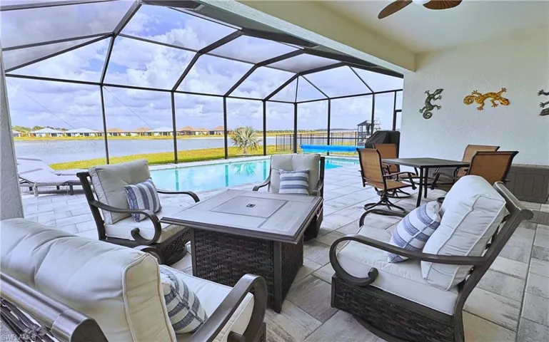 View of patio / terrace with a water view, outdoor lounge area, and glass enclosure