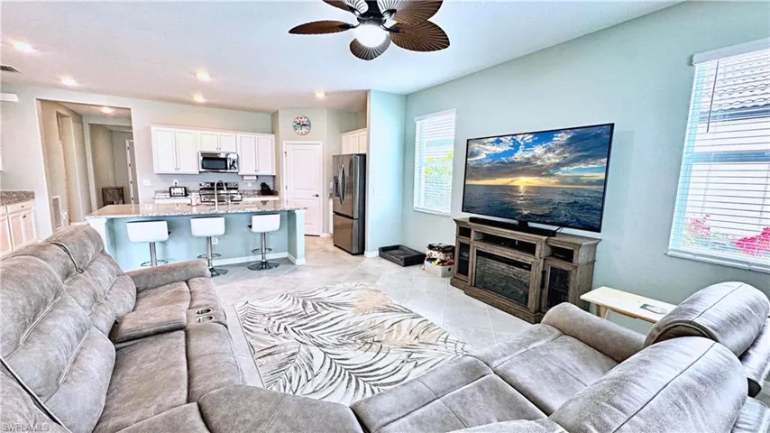 Tiled living room featuring ceiling fan