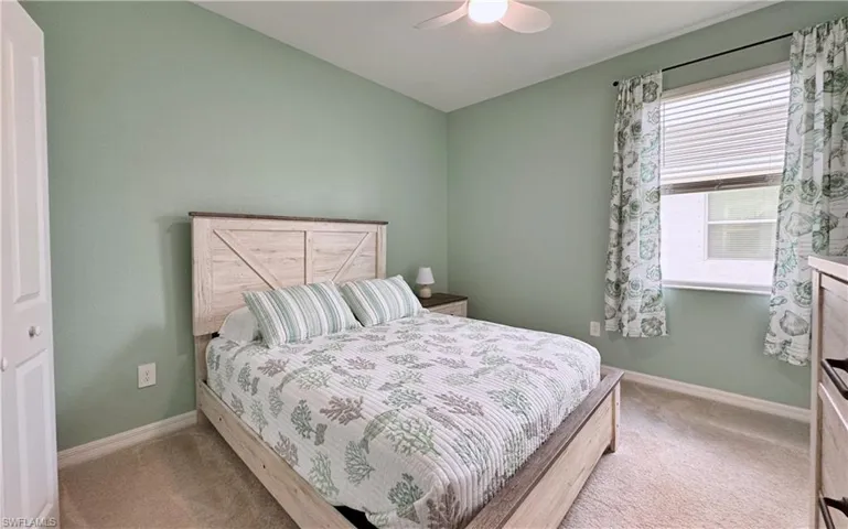 Bedroom with light carpet and ceiling fan