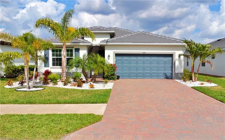 View of front of house featuring a garage and a front yard