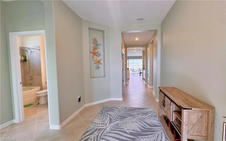 Corridor with light tile patterned floors