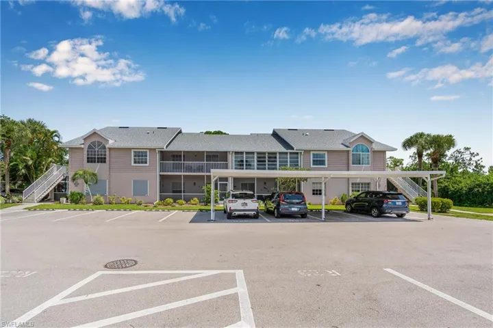 Partially covered parking lot featuring stairs