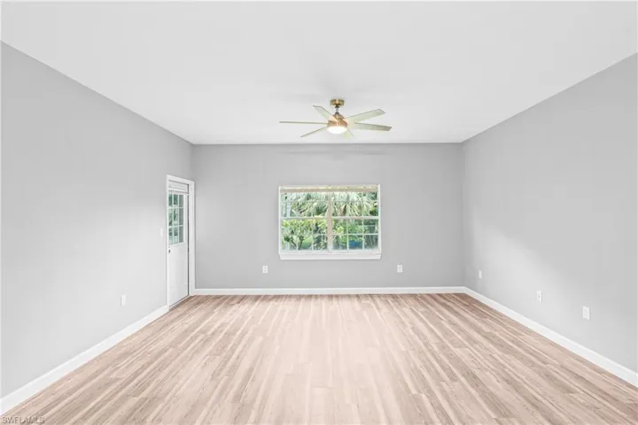 Unfurnished room featuring light wood-style flooring and a ceiling fan
