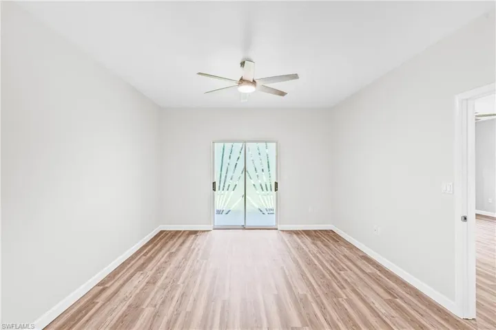 Empty room featuring light wood finished floors and a ceiling fan