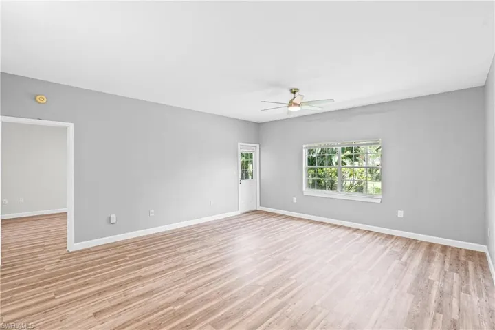 Empty room with light wood-type flooring and a ceiling fan