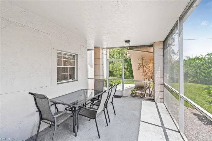 Sunroom featuring outdoor dining area