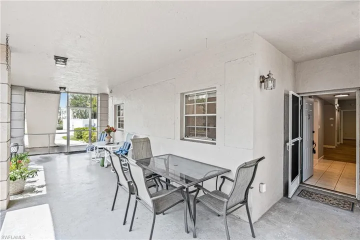 Sunroom featuring outdoor dining area