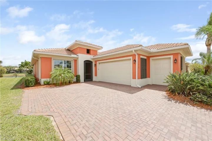 Mediterranean / spanish-style house featuring a garage, stucco siding, decorative driveway, and a tiled roof