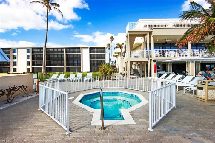 View of pool featuring a hot tub and a patio