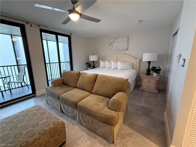 Bedroom featuring ceiling fan and access to lanai