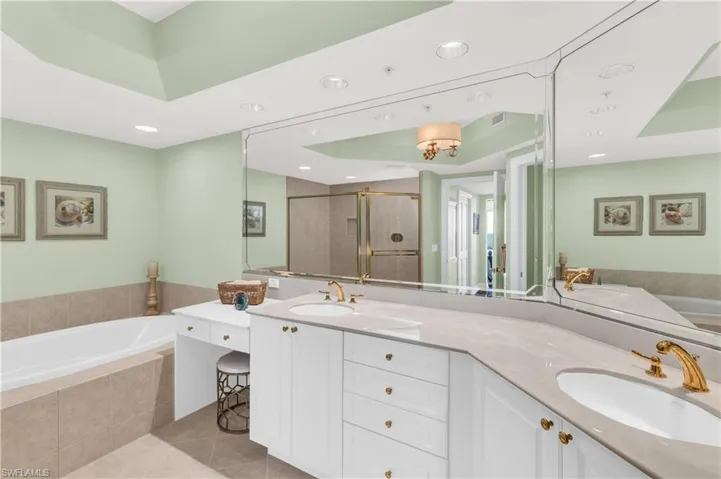 Bathroom with tile patterned floors, vanity, and independent shower and bath