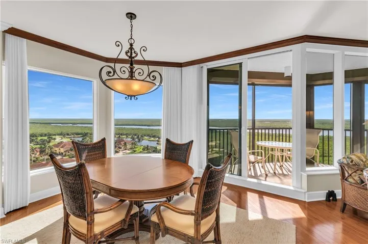 Dining room with light hardwood / wood-style floors and ornamental molding