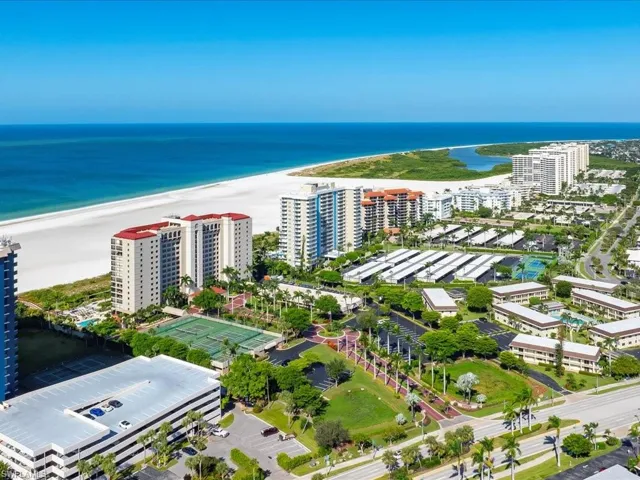 View of urban area featuring waterfront with a beach