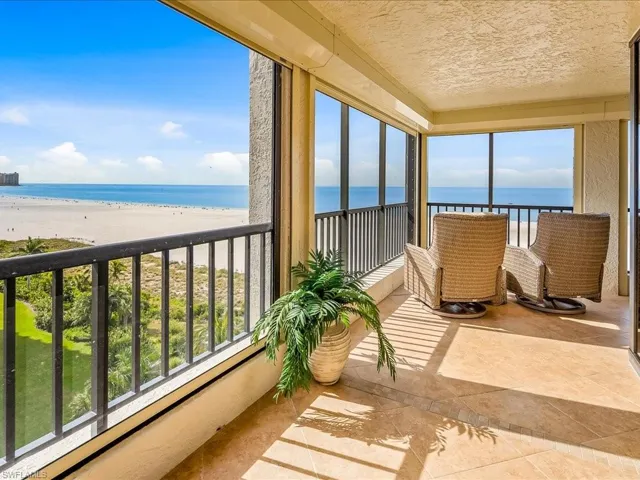 Balcony with view of water and beach