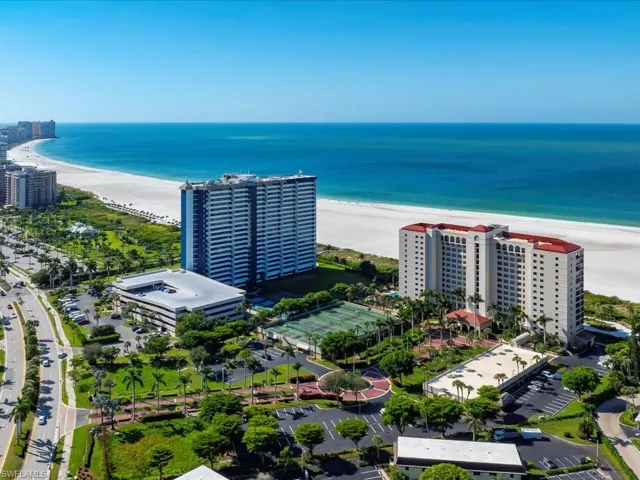 Aerial view of unending shoreline and apartment complex / building