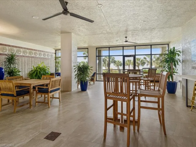Dining area with floor to ceiling windows, a textured ceiling, and ceiling fan