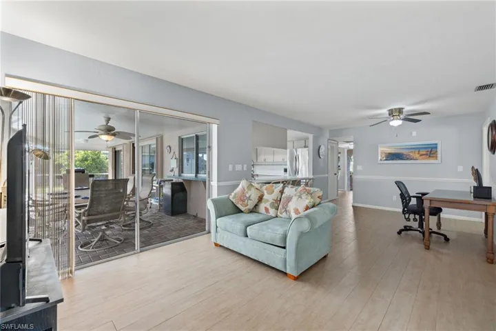 Family room featuring light plank floors and ceiling fan