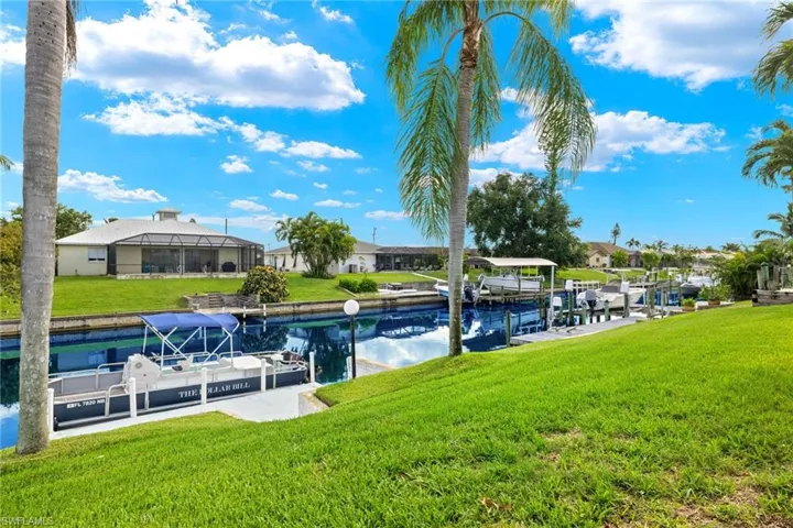 Dock area featuring a water view and a yard