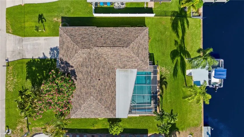 Birds eye view of property with a water view