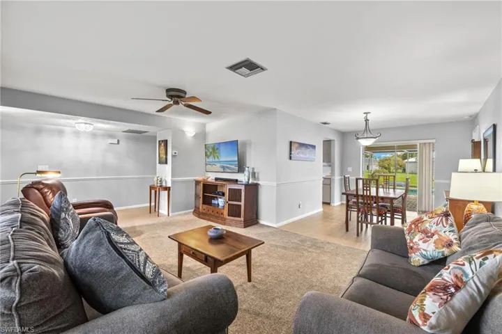 Living room featuring ceiling fan and light wood-type flooring