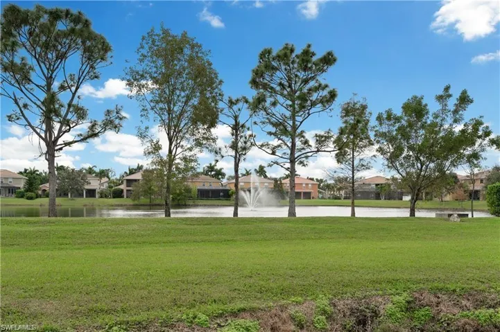 View of home's community featuring a residential view, a yard, and a water view