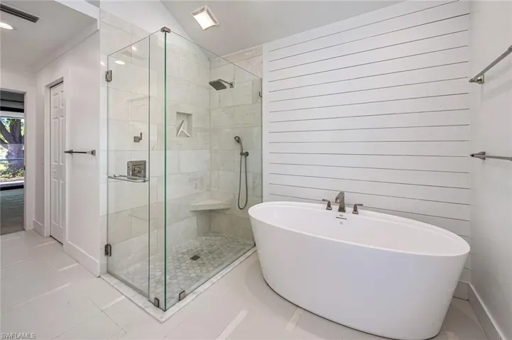 Bathroom with a soaking tub, visible vents, a shower stall, and tile patterned flooring