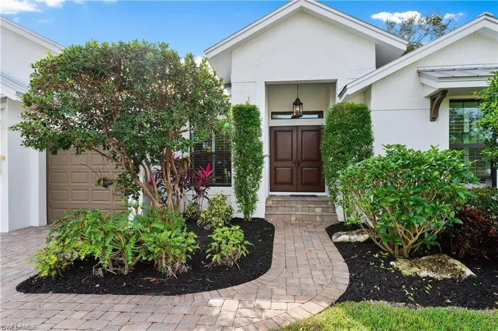 Doorway to property featuring stucco siding