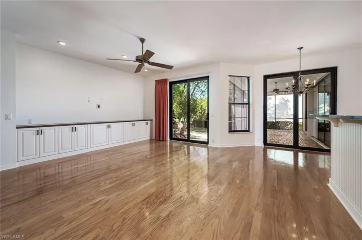 Large family room off kitchen and open to screened lanai and patio for entertaining