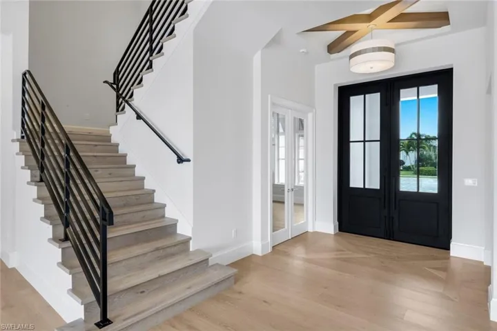 Entrance foyer with french doors and light wood-type flooring