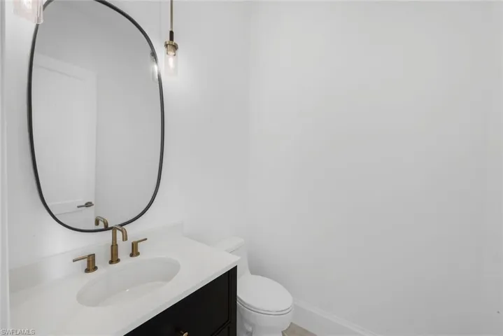 Half bath featuring vanity and toilet