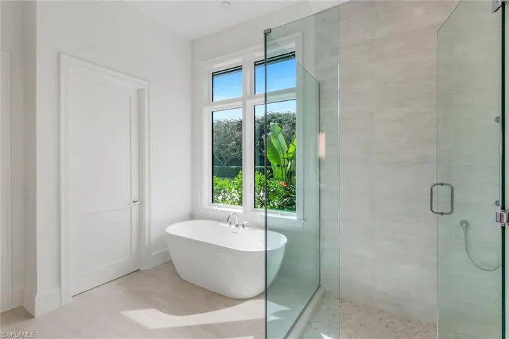 Bathroom with a stall shower and a soaking tub
