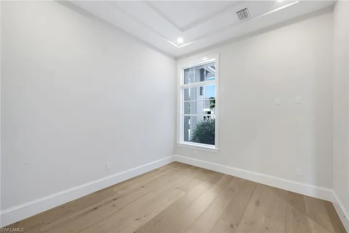 Unfurnished room featuring light wood finished floors and baseboards