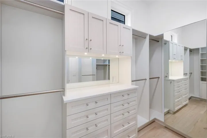 Walk in closet featuring light wood-style flooring
