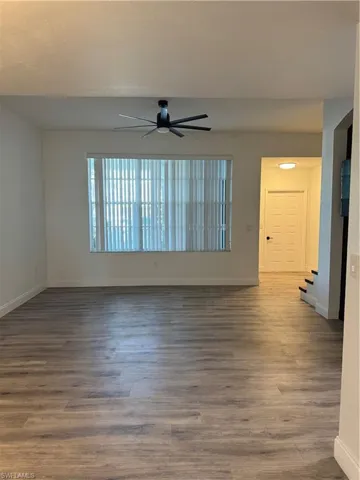 Unfurnished room featuring ceiling fan and wood-type flooring